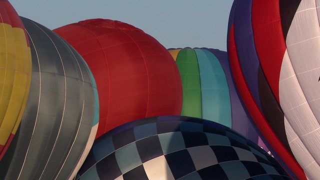 Domes of hot air balloons on sky background