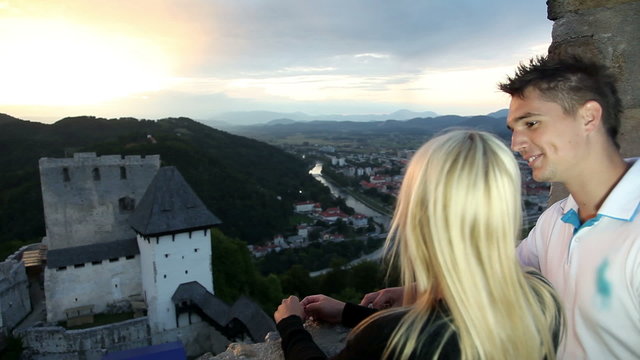 Romantic couple enjoying the view from a castle over the city
