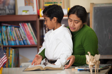 HIspanic Mom and Boy in Homeschool Setting During Worship