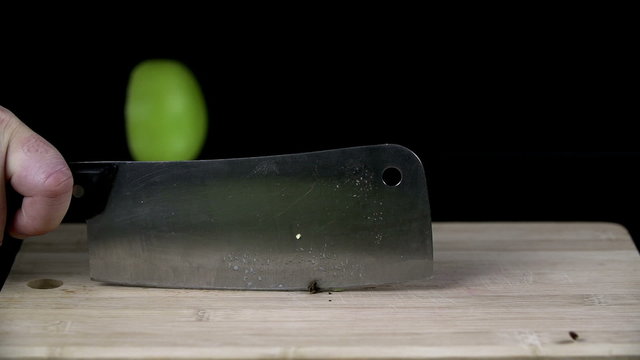 Green apple chopped up in half with a cleaver
