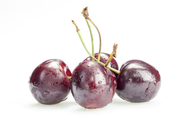 Four cherry berries isolated on white background