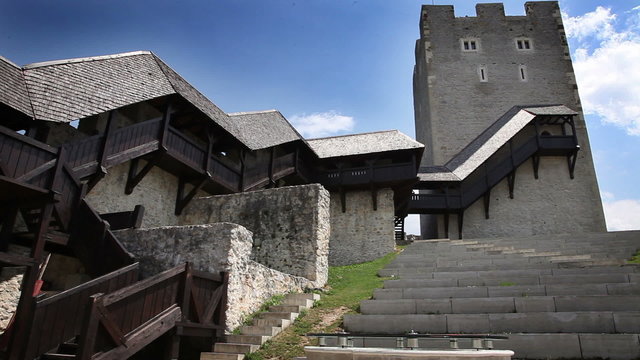 Shot of an old castle near Celje with young woman looking at the map of the