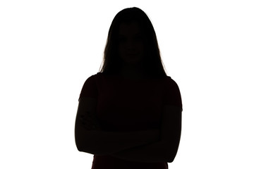 Silhouette of teenage girl with arms crossed