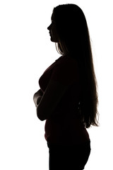 Silhouette of teenage girl standing in profile