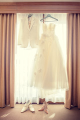 The Wedding Dress hanging at the window