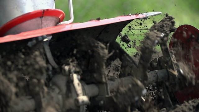 Cultivating land in extreme close up slow motion