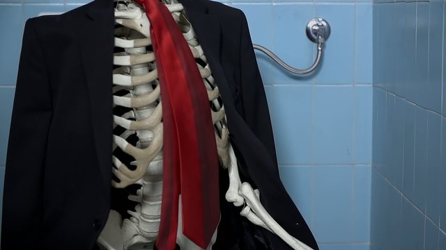 Close shot of skeleton in the toilet taking care of his needs