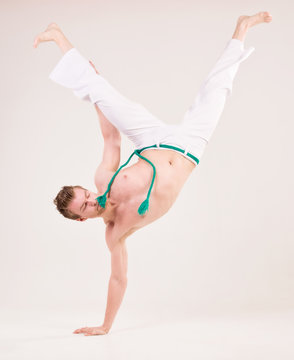 Capoeira dancer on white background