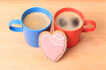 two coffee cups and heart cookies