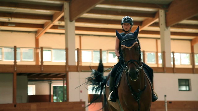 young jockey girl riding horse and learning with male trainer for equestrianism