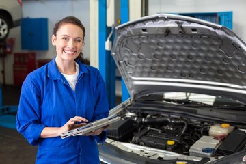 Mechanic using tablet to fix car