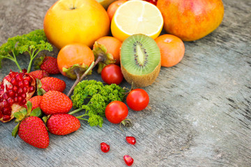 Fototapeta na wymiar Fruits, vegetables on wooden background
