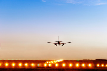 Fototapeta na wymiar passenger plane fly down over take-off runway from airport