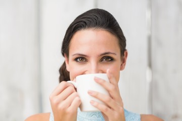 Stylish brunette holding a mug