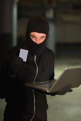 Hacker using laptop to steal identity