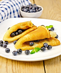 Pancakes with blueberries on board