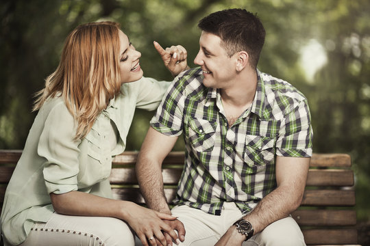 Cheerful couple talking and smiling outdoors.