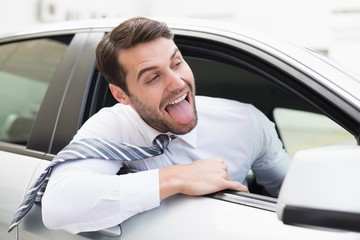 Carefree businessman sitting in drivers seat