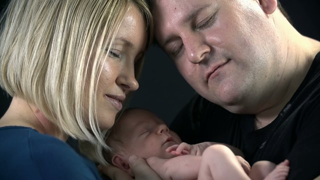 Close shot of parents and their newborn
