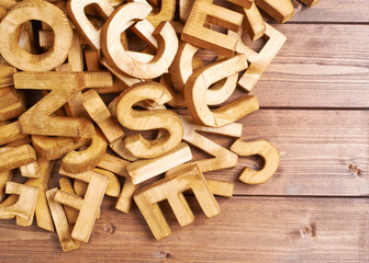 Pile of wooden letters over the wooden surface