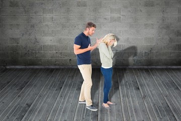 Naklejka premium Composite image of young couple having an argument