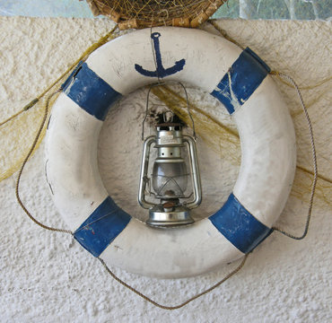 Decorative old life ring with oil lamp