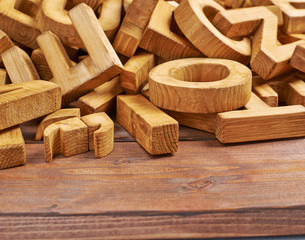 Pile of wooden letters over the wooden surface