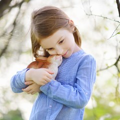 Adorable little girl holding easter bunny