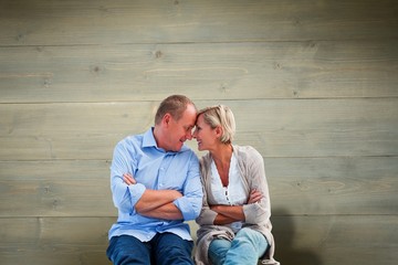 Composite image of happy mature couple smiling at each other