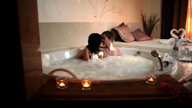 HD1080p: Shot of a couple kissing in a private jacuzzi.