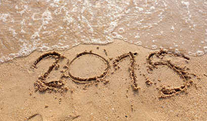 Beaches waves and text 2015 drawn in the sand.