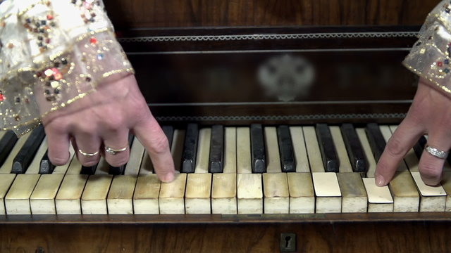 Female hands play piano keys from a wrong way