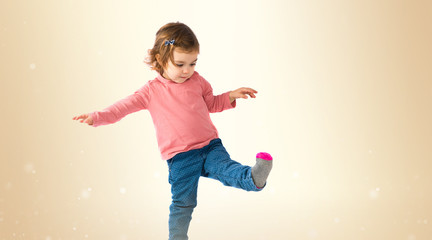 Little girl walking over white background