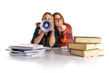 Friends shouting by megaphone while studying