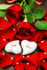 Red roses and two white hearts. Valentines Day. With Love