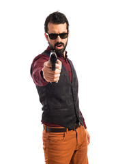 Man wearing waistcoat shooting with a pistol