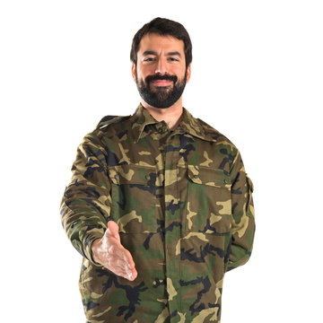 Soldier making a deal over white background