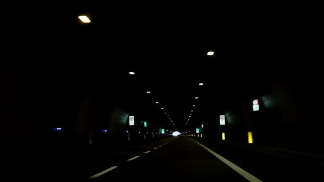 a road and driving in the dark tunnel