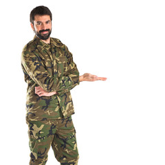Soldier presenting something