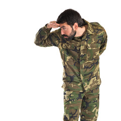 Soldier showing something over white background