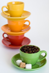 Green cup with coffee grains and sugar