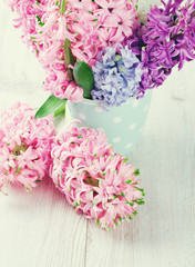 colorful hyacinth flowers in a polka dot cup