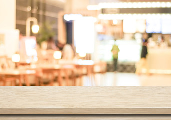 Empty wood table and blurred cafe with bokeh light background