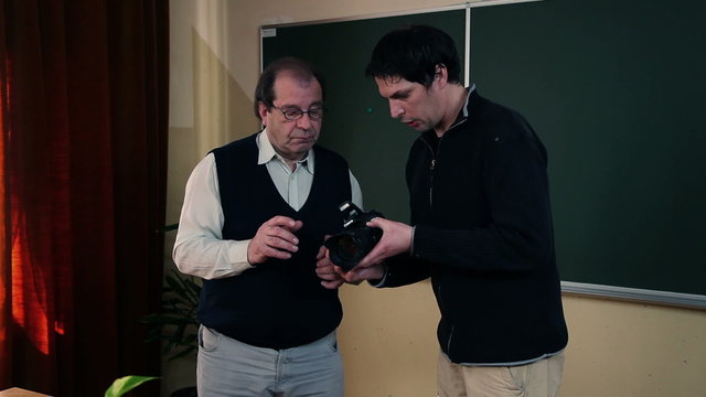 Instructor is explaining to a participant how to work with digital camera