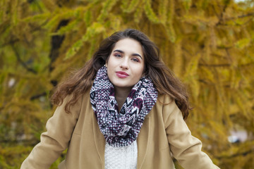 Beautiful young woman in autumn park