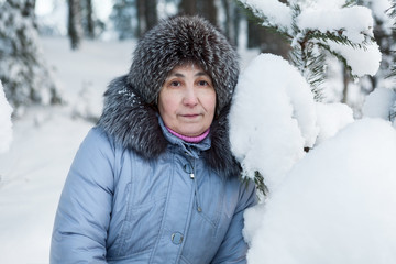 Serene mature woman portrait in winter forest
