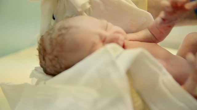 Nurse clean a just-born baby child 

