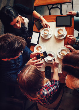 Friends In Cafe Drinking Coffee