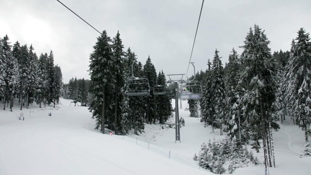 a idyllic ski slope and cableway in the winter time full of snow