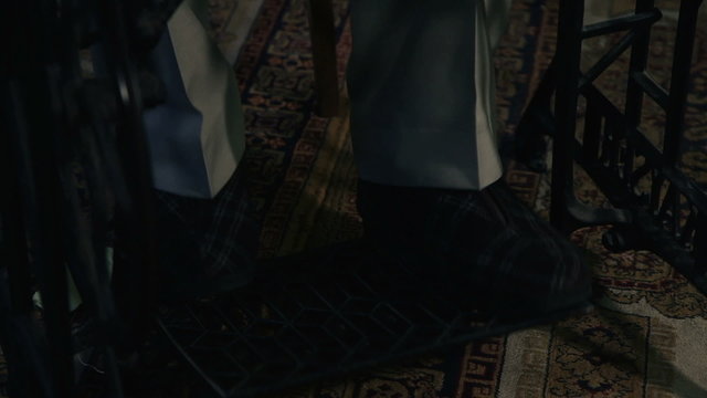Close up shot of the tailor`s legs ,  running a sewing machine